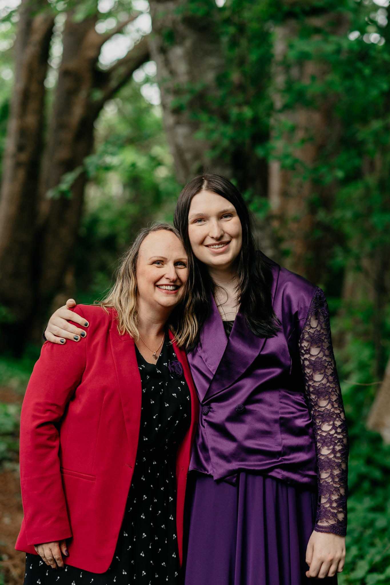 Two founders of Reimagine Housing Society standing together among trees